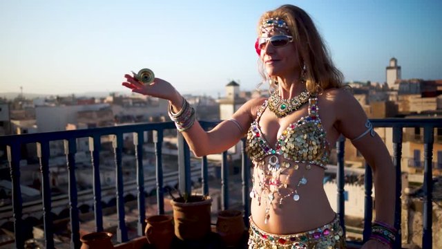 Extreme closeup of belly dancer performing at sunset in Essaouira, Morocco.
