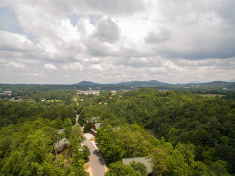 View from the top of a hill in a cabin community in the tourist city of Pigeon Forge Tennessee. The Great Smokey Mountains can be seen in the distance