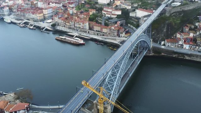 Beautiful aerial shot of a bridge being built in Porto, Portugal. Slow zoom in shot.