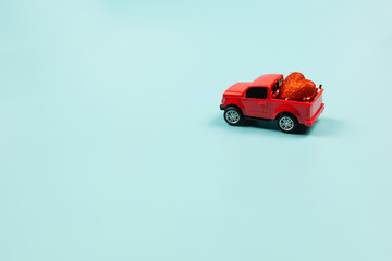  Valentines Day Concept. Retro red toy car with red heart
