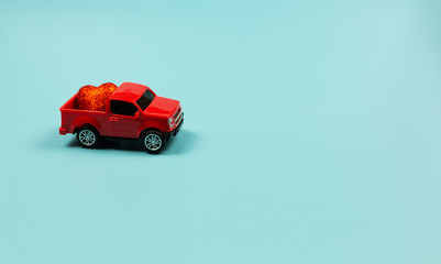  Valentines Day Concept. Miniature red toy car with red heart