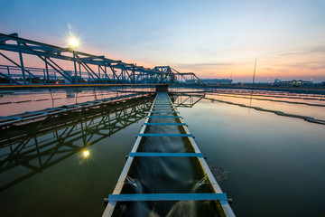 Water treatment plant with sunset. water treatment plant, ecosystem, waste water, water recycle, water purification or environment industry concept - obrazy, fototapety, plakaty