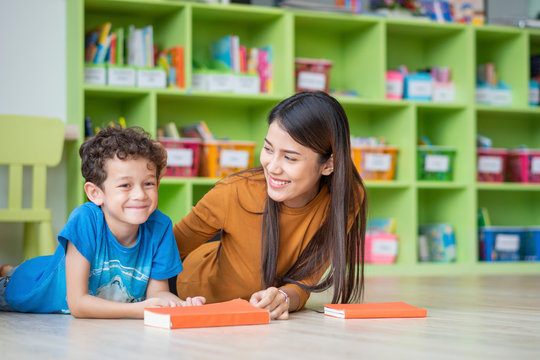 portrait of Asian teacher teaching kids in international school