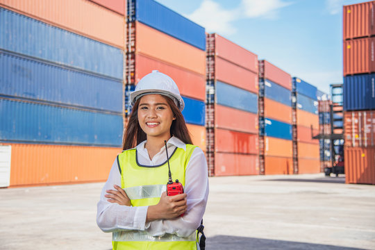 portrait of logistics engineer with safety helmet stand in shipyard in sunny day