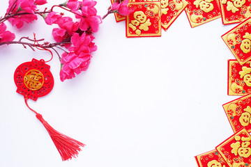 Chinese New Year flat lay white background with assorted festival decorations. Chinese characters...
