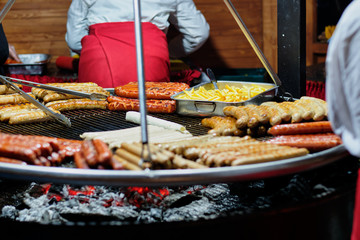 Street food at the main city fair Kebab, corn, grilled sausages.