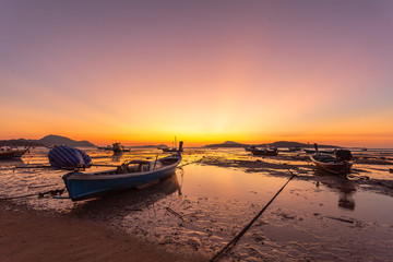 Naklejka na ściany i meble scenic reflection of beautiful sunshine in the sea fishing boats are floating in the Rawai sea