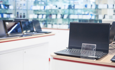 Laptop on the table in the electronics store.