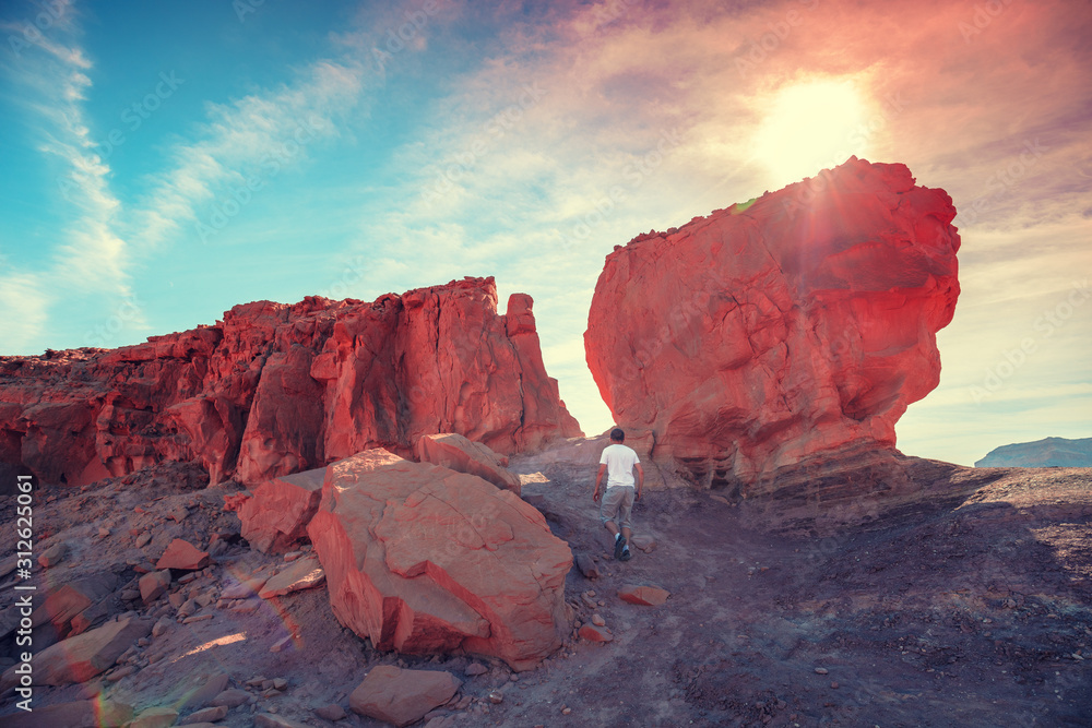 Wall mural a man climbs on a rock. desert natural landscape. timna park. israel