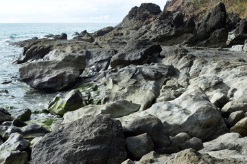 Fototapeta na wymiar seawaves pounding rock formation on ocean waterfront