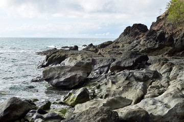 Fototapeta na wymiar seawaves pounding rock formation on ocean waterfront