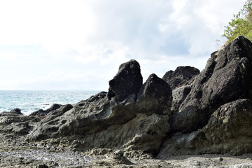 seawaves pounding rock formation on ocean waterfront