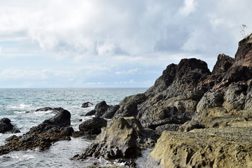 seawaves pounding rock formation on ocean waterfront
