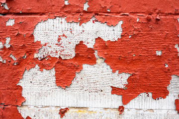 An old brick wall with chipped red paint