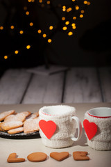 cup, heart, christmass tree and lamps in the background