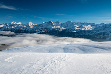 Fototapeta na wymiar Eiger Mönch and Jungfrau in winter with snow drifts
