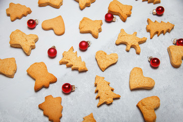 A scattering of Christmas cookies on a gray background. Flat layout. Top view. Christmas and new year concept. Cooking