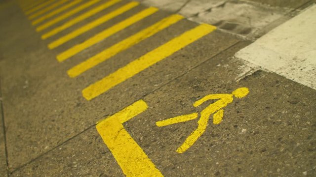 Pedestrian crosswalk with yellow marking lines in the factory