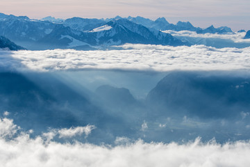 Fototapeta premium layer of clouds with tyndall effect at the flank of Mount Niesen at the entrance of Simmental Valley
