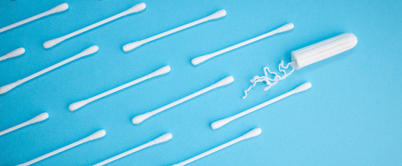 Menstruation. Women intimate hygiene concept. Tampon and hygiene sticks on the blue background. Health and bodycare.