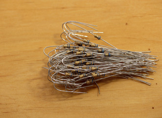 Electronic components: resistors on wooden background. Two-terminal passive components.