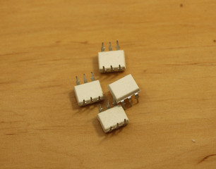 Electronic components. Optocoupler with six pins on wooden background. Microchip.