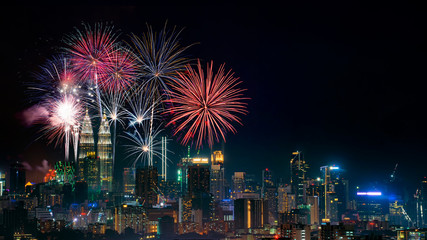 Firework display on Kuala Lumpur city with text happy new year 2020