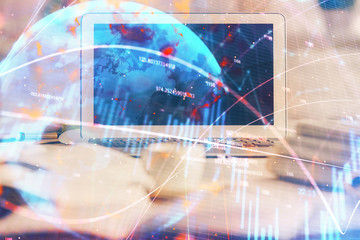 Financial graph colorful drawing and table with computer on background. Multi exposure. Concept of international markets.