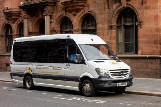 Mercedes-Benz Sprinter touristic shuttle bus of the Escocia Turismo company at the streets of Glasgow