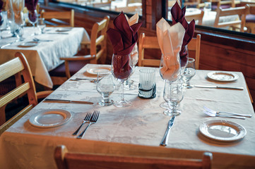 Rustic wooden dining table with tableware and glass