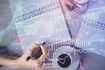 Multi exposure of woman's hands making notes with forex graph hologram. Concept of technical analysis.