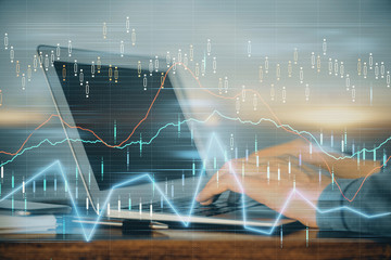 Double exposure of stock market graph with man working on laptop on background. Concept of financial analysis.