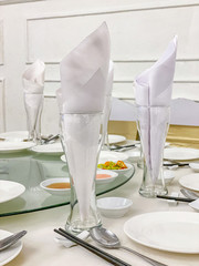 Elegant banquet table setting with glass and white ceramic tableware 