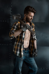 Brutal bearded man in a plaid shirt