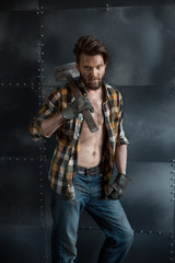 Brutal bearded man in a plaid shirt