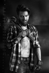 Brutal bearded man in a plaid shirt