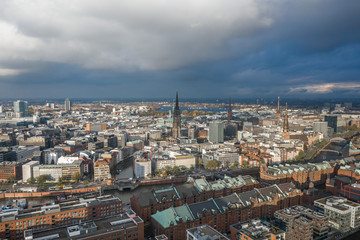 Aerial drone view of historical center near Port of Hamburg with sunset light over the red brick city