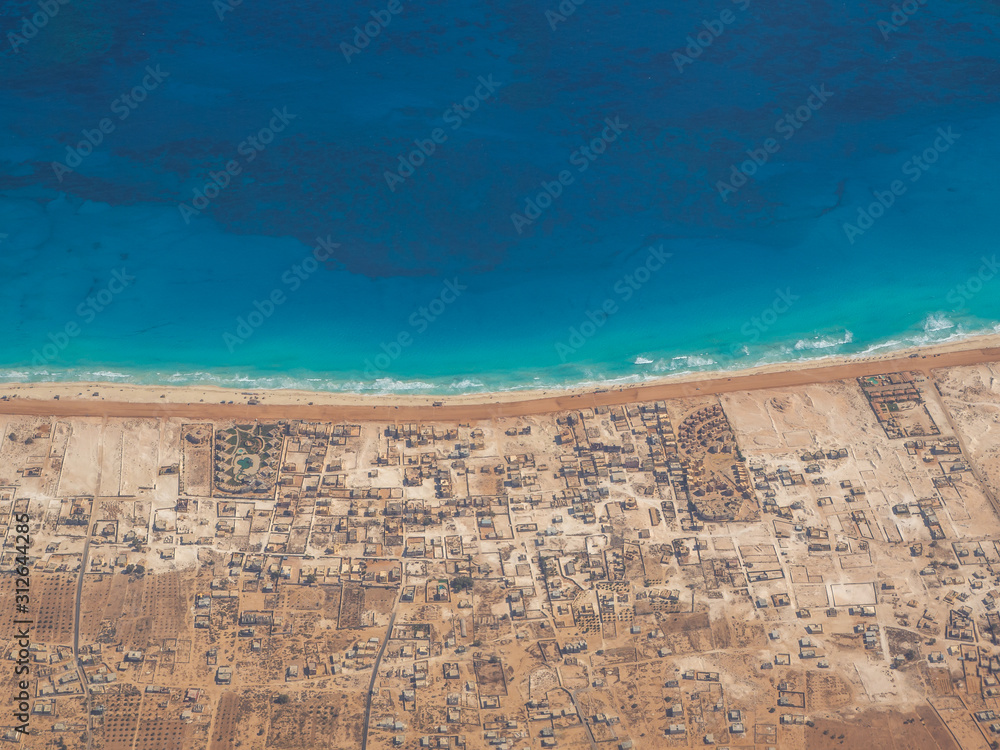 Wall mural earth's line. a perspective of the ground's colors and shapes. aerial view of the egyptian coast ove