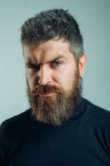 Obraz premium Handsome bearded man. Brutal hipster boy. Confident concept. Urban lifestyle concept. Man with confident face and brutal style isolated. Barbershop advertising. Copy space.