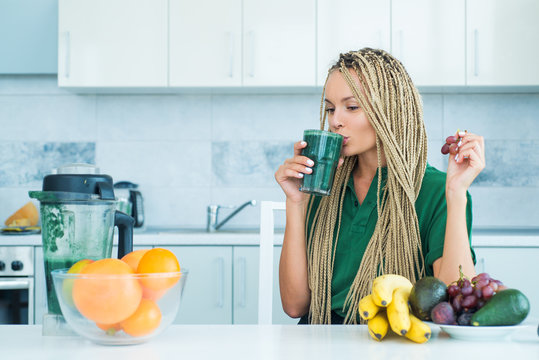 Fresh spirulina. Diet concept. Healthy summer drink. Well being and weight loss concept. Blonde healthy girl drinks green smoothie. Healthy life and food concept. Perfect body and calorie.