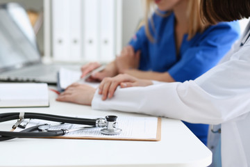 Fototapeta premium Stethoscope head lying on medical forms