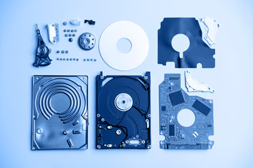 Disassembled laptop hard drive on a white background. Toning in trendy color 2020 classic blue.