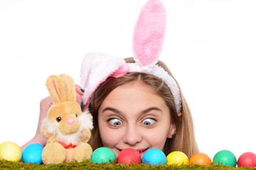 Fototapeta na wymiar Surprised girl wear bunny ears on Easter day. Young woman with painted eggs on green grass, spring. Happy Easter concept. Cute girl with decorated easter eggs isolated at white background.