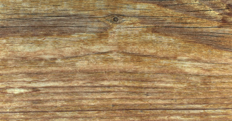 Fototapeta premium Pine wood texture. Flat old vintage pine board surface with knots and curving layers. Top view, Brown color tone.