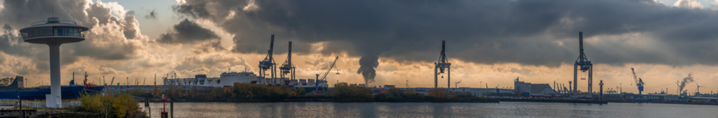 Fototapeta na wymiar Panoramic view of port of Hamburg from Hafencity during sunset with dramatic stormy clouds
