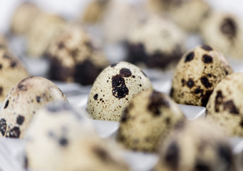 Some fresh Quail Eggs on wooden background (selective focus; close-up shot)