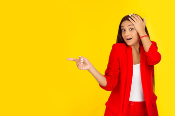 excited woman pointing with index finger to the side