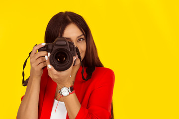young woman taking pictures with professional camera