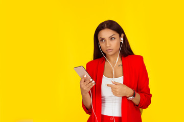 Girl with ear pods and cellphone listening carefully.