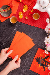 Design concept of Chinese lunar January new year - Woman holding, giving red envelopes (ang pow,...